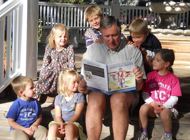 Kirk reading to his grandchildren