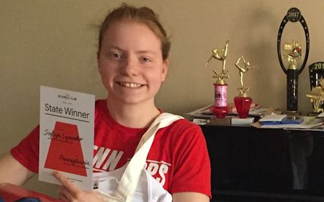 Sofiya Lysenko holding her science awards.