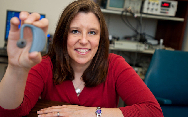 Researcher holding a wearable communication device