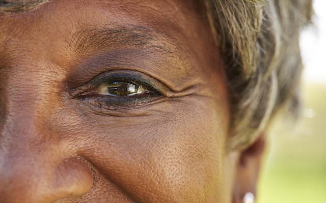 Close Up Of Smiling Senior Womans Eyes In Park