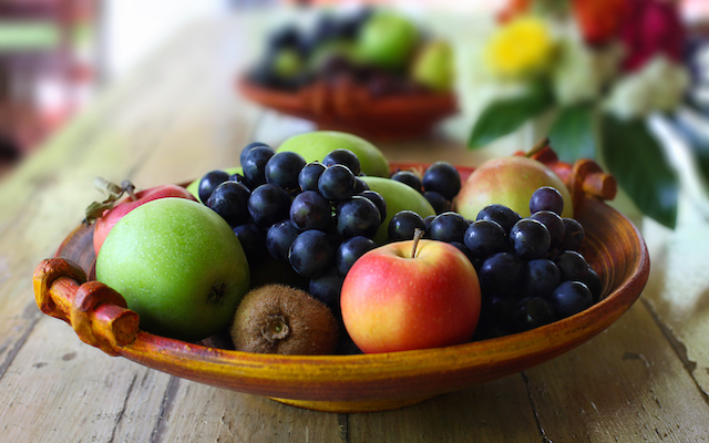 A bowl of fruit sits on a table.