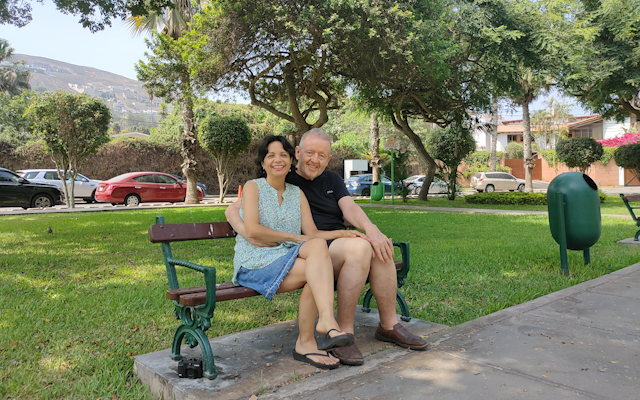 A picture of Ray Feeney and Ana María Tamayo outside sitting on a bench.