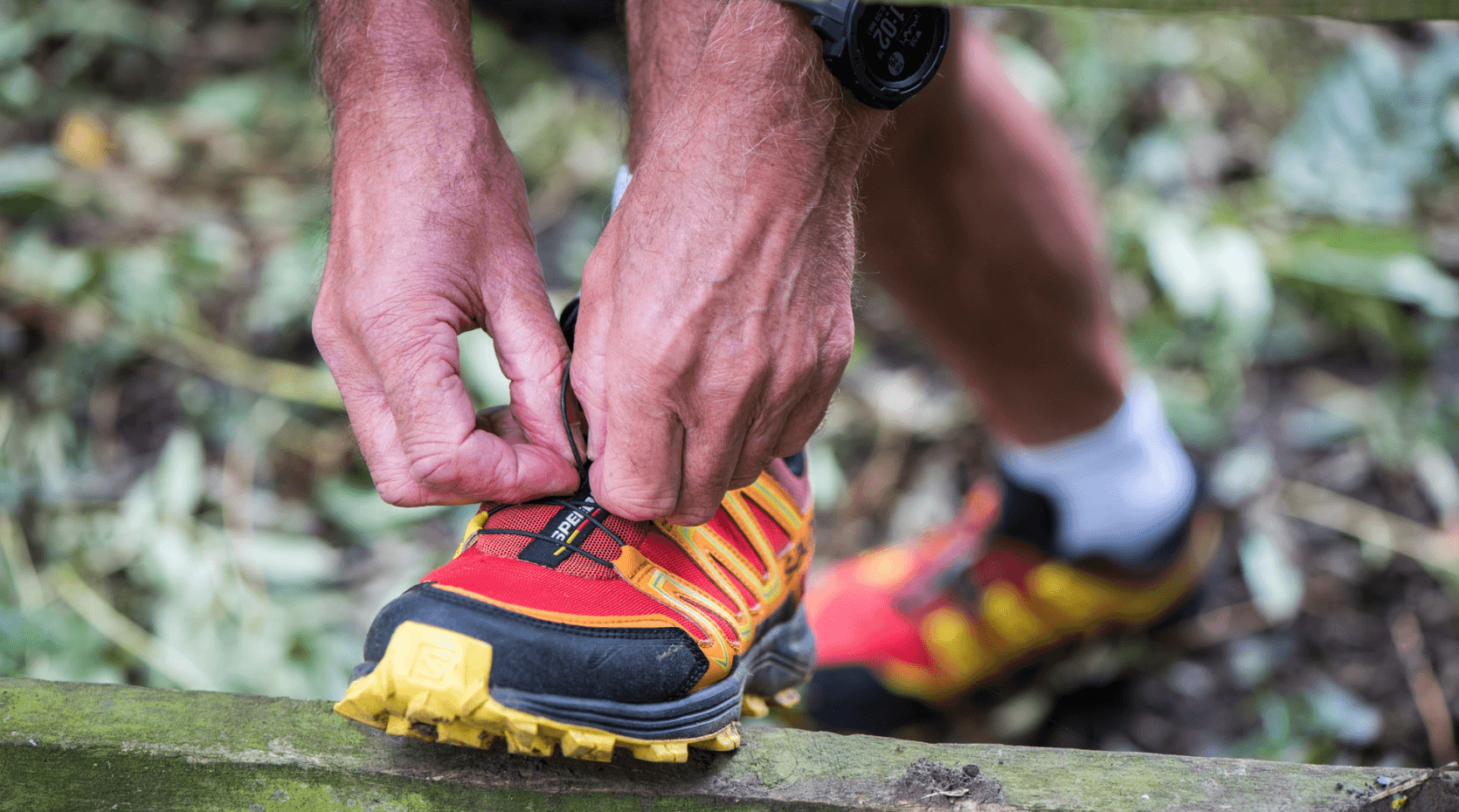 A photo of a man tying some running shoes to symbolise National Walking Month 2024
