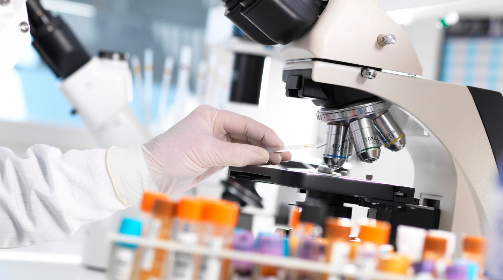 A photo of a research examining things through a microscope in a Parkinson's research trial