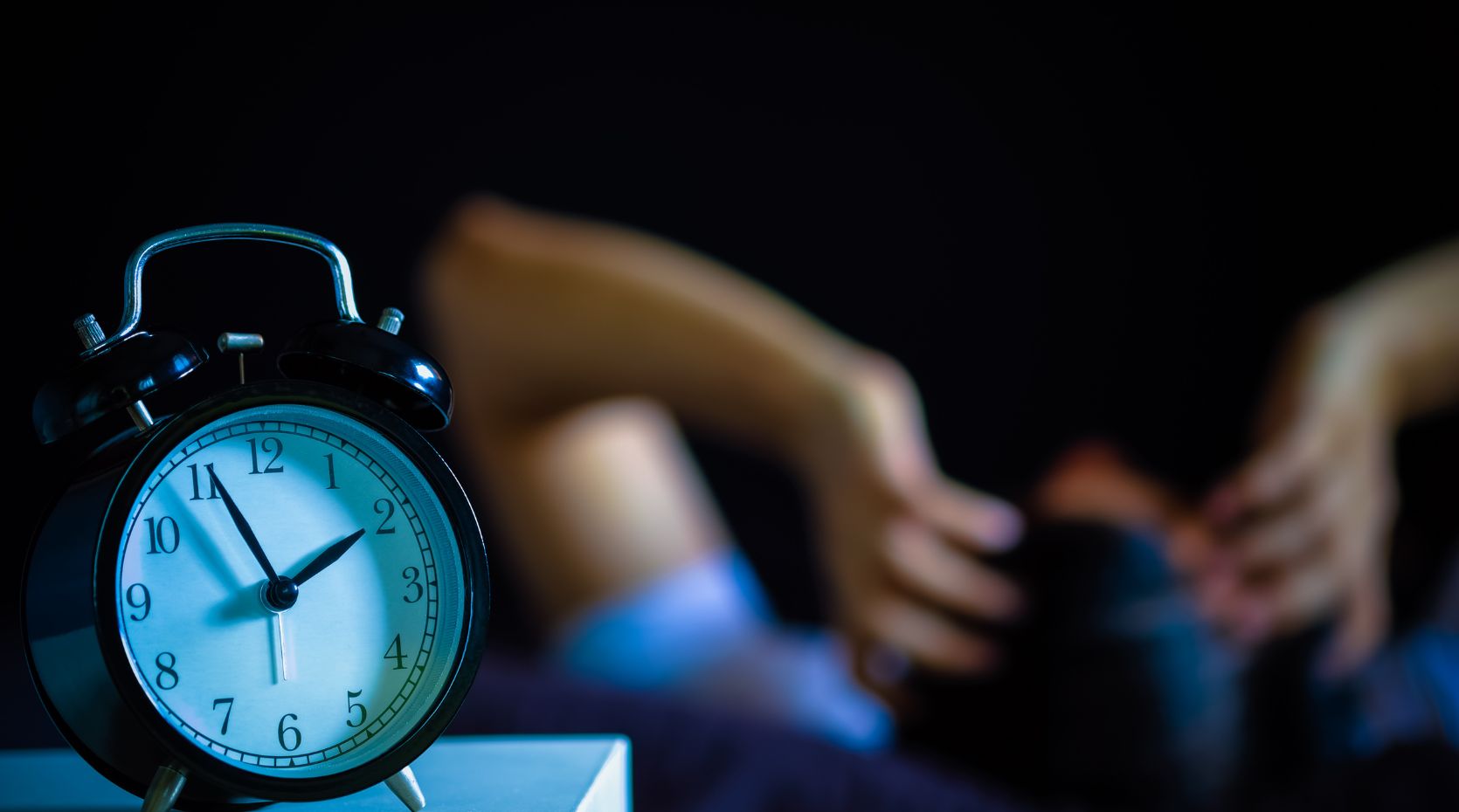 A person with Parkinson's sleep issues laying in bed