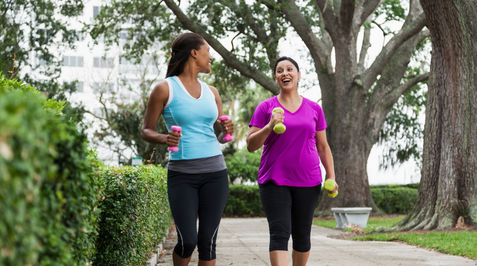 A photo of two women exercising to signify how often to change your exercise routine