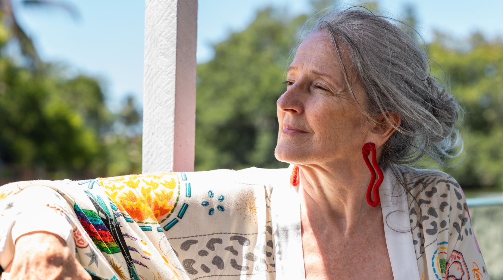 Women and Parkinson's: older woman looking over shoulder smiling