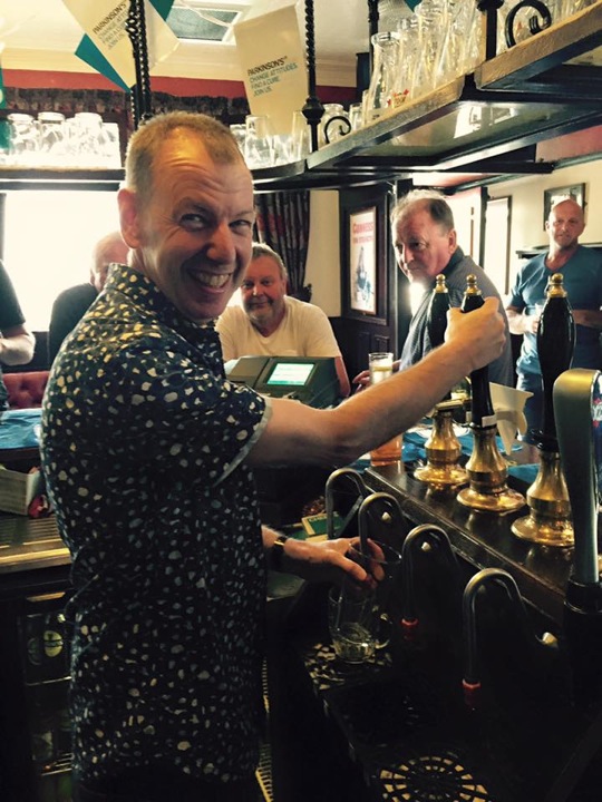Alan Comer pulling pint
