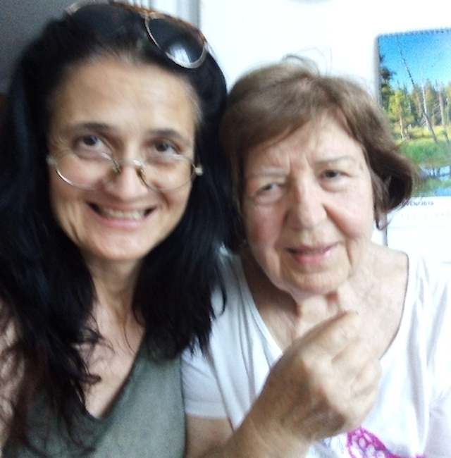 Two women pose together.