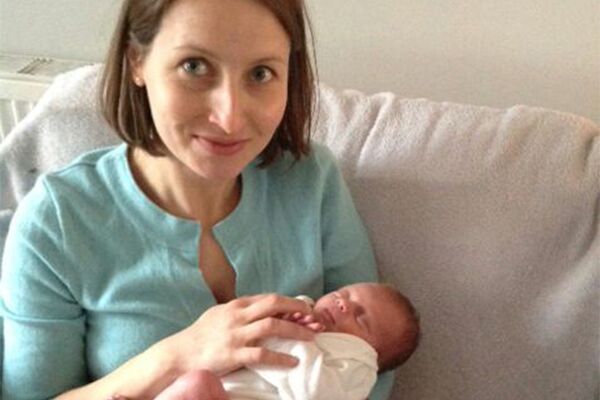 A mother holding a young baby
