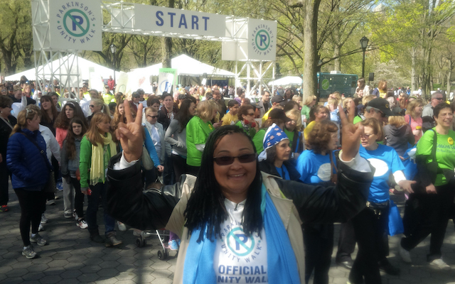 Maryum Ali stands in front of a crowd at a Parkinson Alliance Unity Walk.