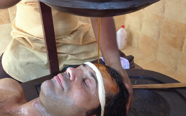 Massimiliano Iachini undergoing Shirodhara, an Ayurvedic healing technique, in Kerala, India.