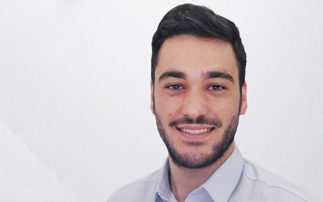 Dr Daniele Urso smiles for a portrait.