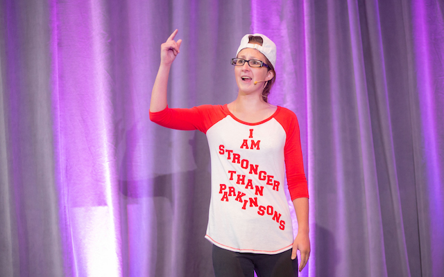 Samantha Felder at a performance, wearing a shirt that says 'I am stronger tha Parkinson's'.