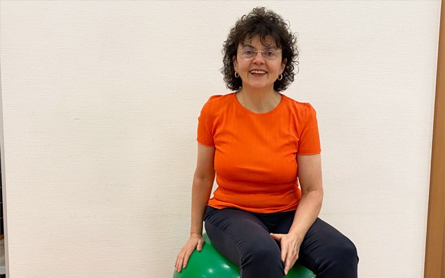Physiotherapist Mariella Graziano sits on an exercise ball.