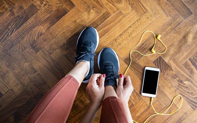 Woman tying up shoelaces on trainers