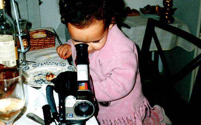 Nina Caprice as a child looking through a camera 