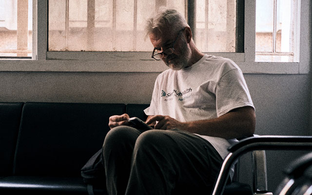 Guy Deacon sitting down in Freetown, Sierra Leone at the very beginning of second leg of the journey