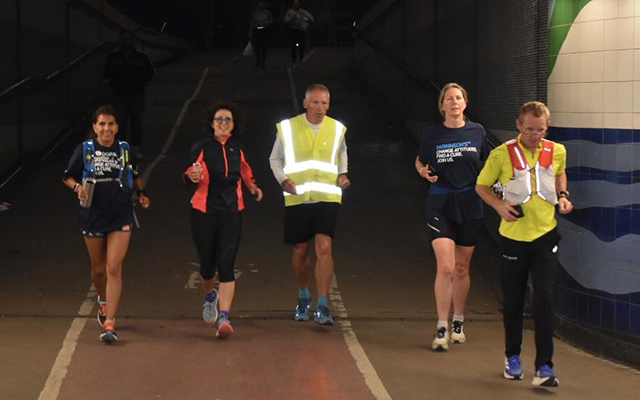 Gary Shaughnessy and several other people running through the nigh