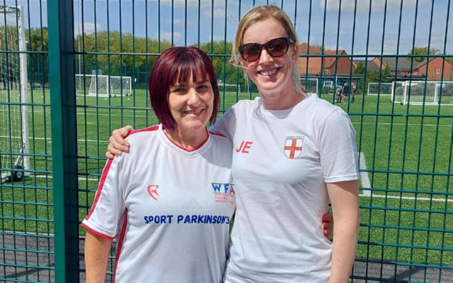 Player Annie Booth standing next to Jo Eastough, the team's Parkinson's specialist physiotherapist