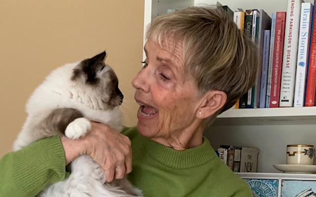 A picture of Leslie Davidson holding her cat Pearl.