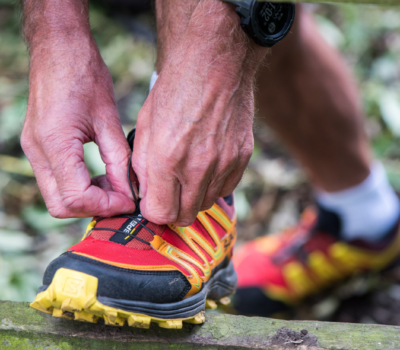 A photo of a man tying some running shoes to symbolise National Walking Month 2024