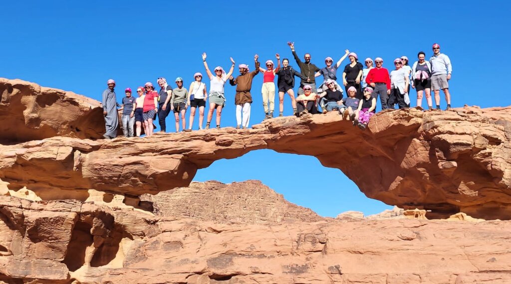 A photo of the Parkili team on top of a rock formation in Jordan