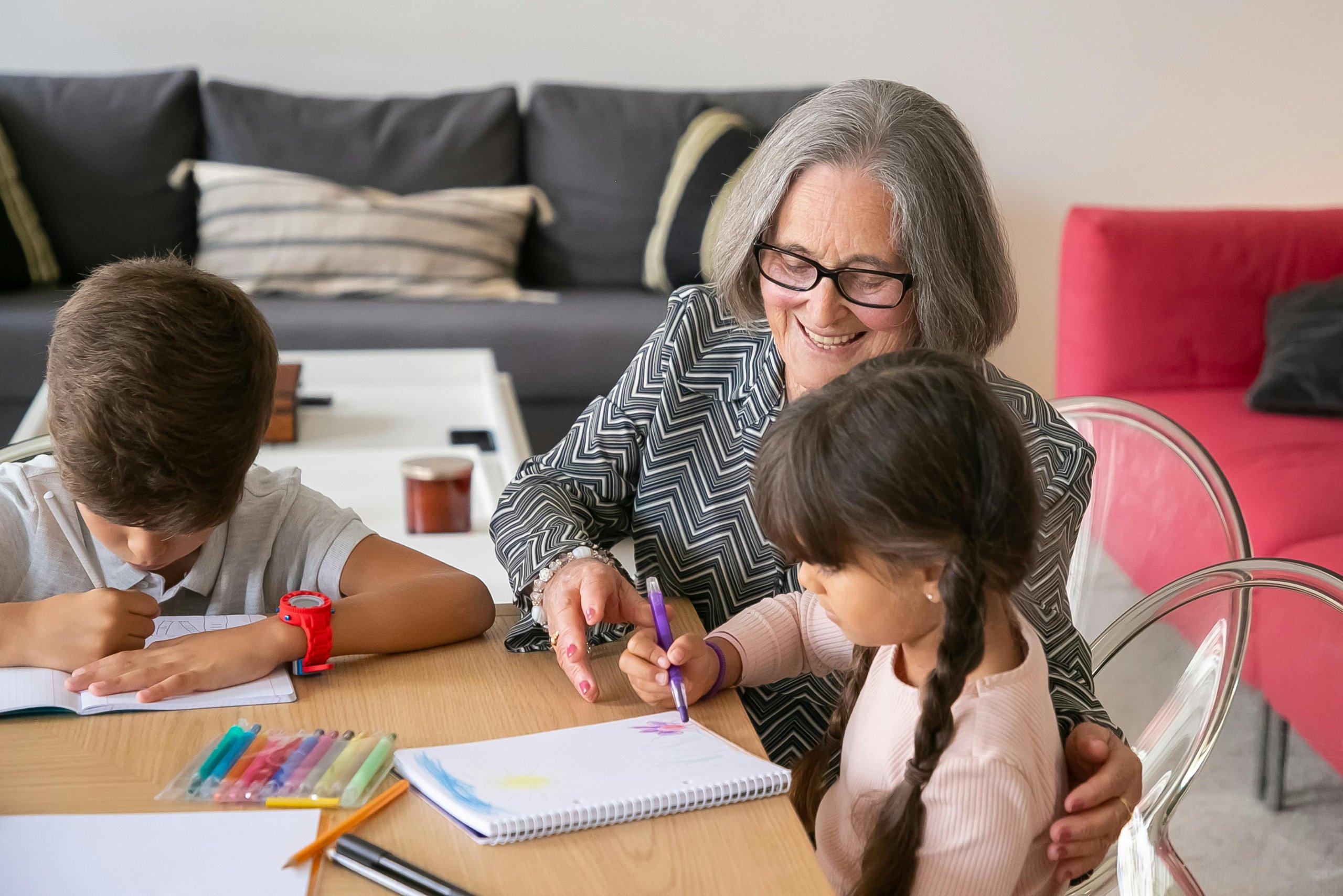 woman smiling and sitting with grandchildren